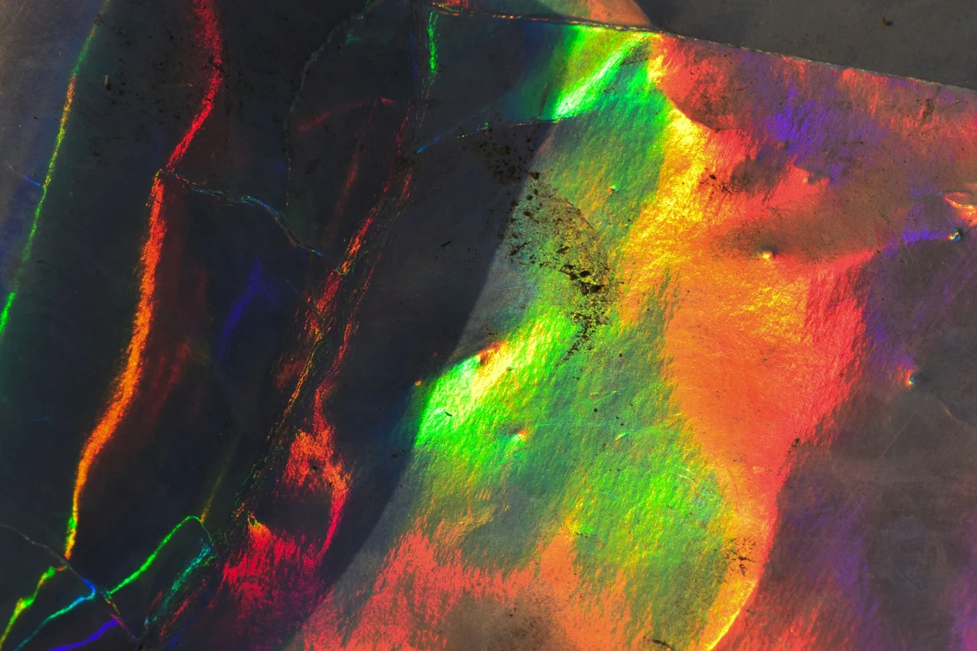 Iridescent material photographed by Saifee Art, shown through a geometric crop